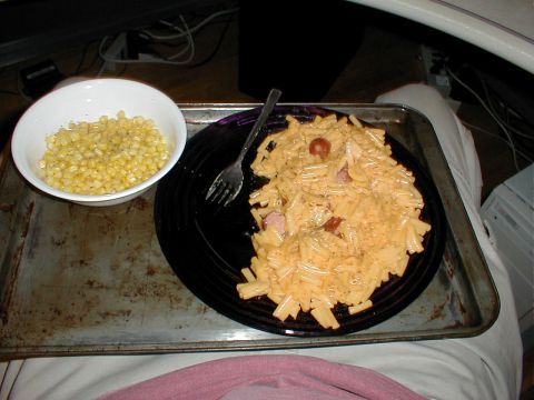 1999 Ford Crown Victoria - A meal of pasta and corn is served on a baking sheet, with a fork resting on the plate.