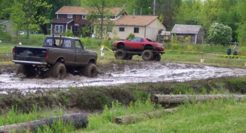 1978 Ford Bronco - Two heavily modified vehicles navigate a challenging mud bog course.