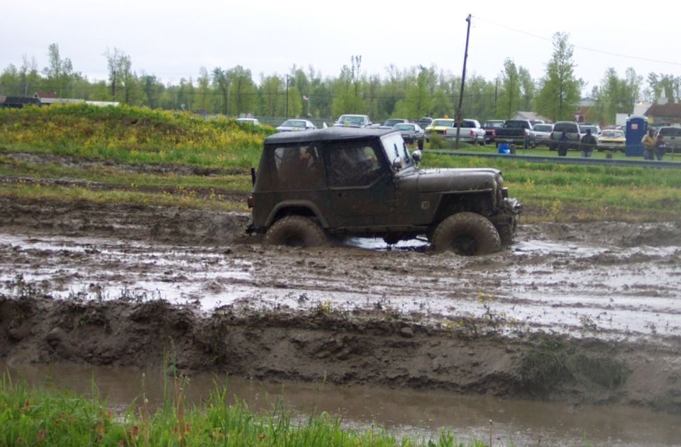 Jeep CJ-5 stuck in deep mud, tires submerged