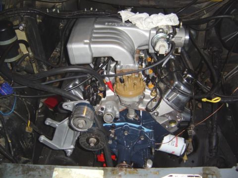 1986 Ford Bronco - Close-up view of a V8 engine, showing the intake manifold, distributor, and oil filter.