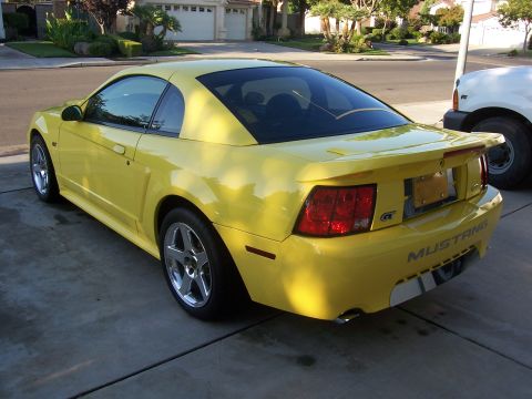 2002 Ford Mustang - This yellow 2002 Ford Mustang GT coupe is shown from the rear 3/4 angle.