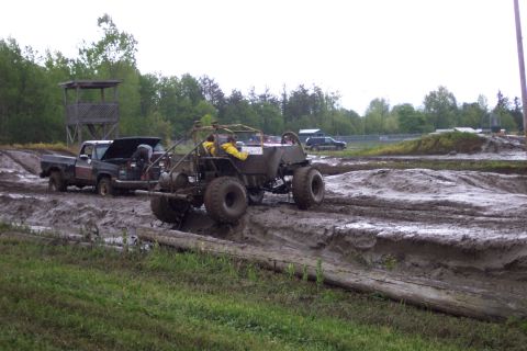 1978 Ford Bronco - Two vehicles are stuck in the mud at a mud bogging event.
