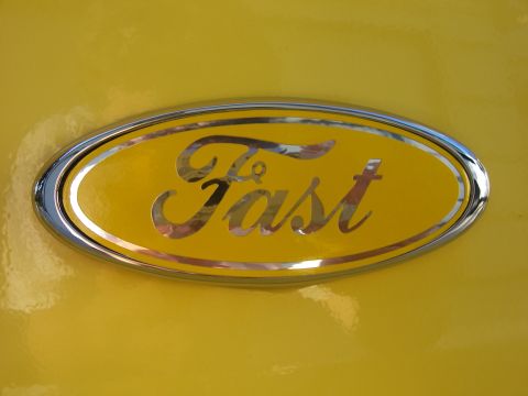 2002 Ford Mustang - Close-up of a Ford emblem modified with the word 'Fast' instead of the Ford logo.