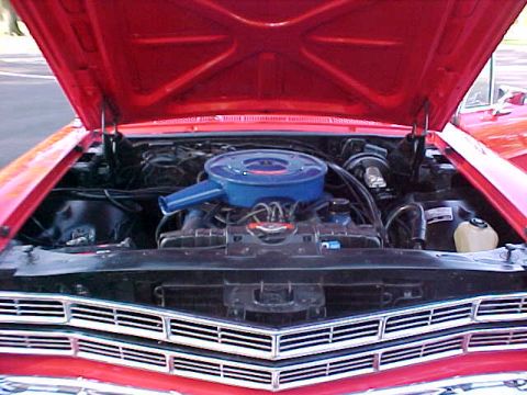 1967 Ford Galaxie - Front view of a red car's engine bay, showing the engine and grille details.