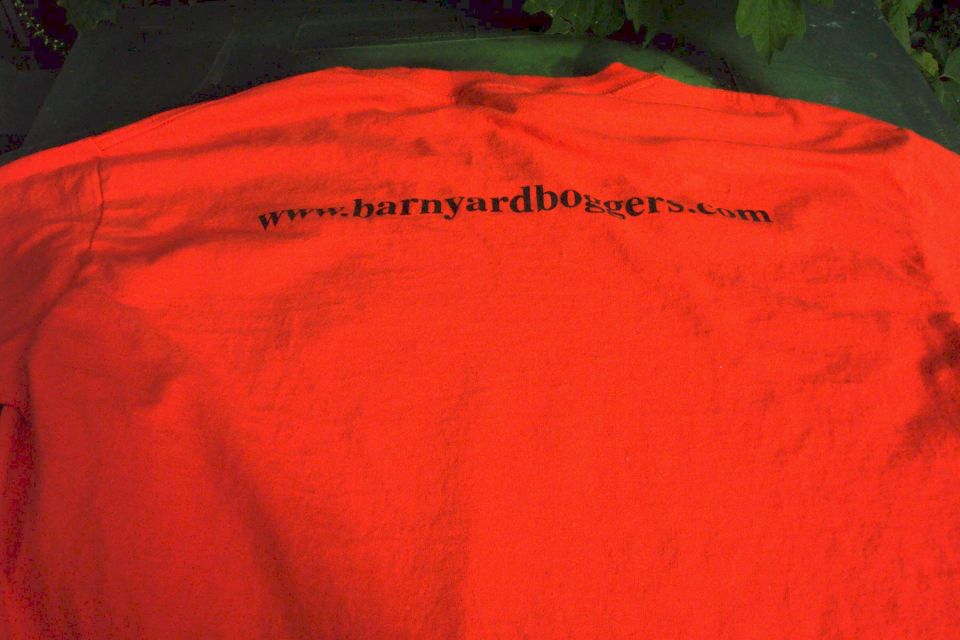 Orange t-shirt with black text 'www.barnyardboggers.com' and 'SUPERMOTORS www.supermotors.net' logo