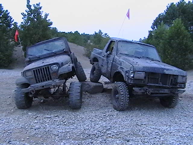 Jeep Wrangler and Ford F-Series truck on rocky terrain