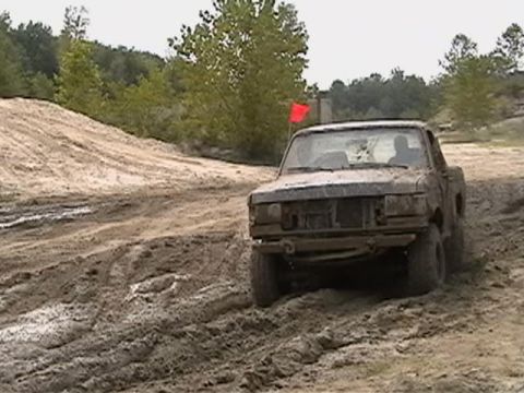 1988 Ford Bronco - Muddy 1988 Ford Bronco navigates a challenging off-road course.