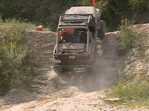 1988 Ford Bronco - An off-road vehicle navigates a steep, dusty incline during an off-road excursion.
