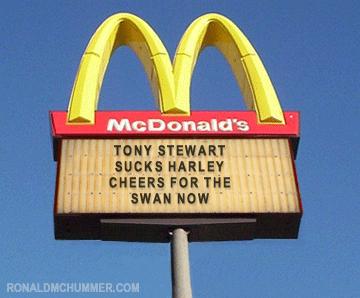 1978 Ford Mustang II - A McDonald's sign displays a message about Tony Stewart and Harley-Davidson motorcycles.