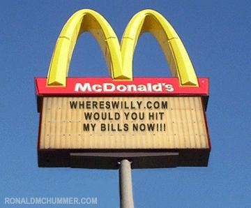 1978 Ford Mustang II - A McDonald's sign displays a message board with text and website addresses against a blue sky.