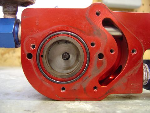 1978 Ford Bronco - This is a close-up view of a red metal fuel pump assembly, showing its internal components and seals.