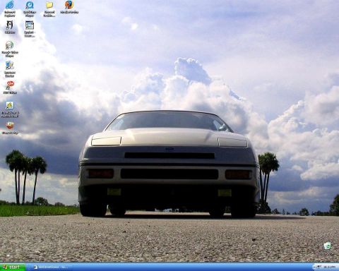 1991 Ford Probe - A 1989 Ford Probe is shown from the front on a road with a cloudy sky and palm trees in the background.