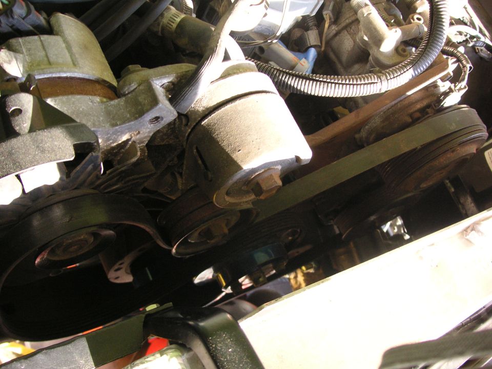 Engine belt system with pulleys and tensioner