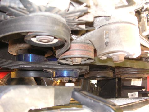 1999 Jeep Grand Cherokee - The image shows a close-up view of the serpentine belt system and pulleys within an engine bay.