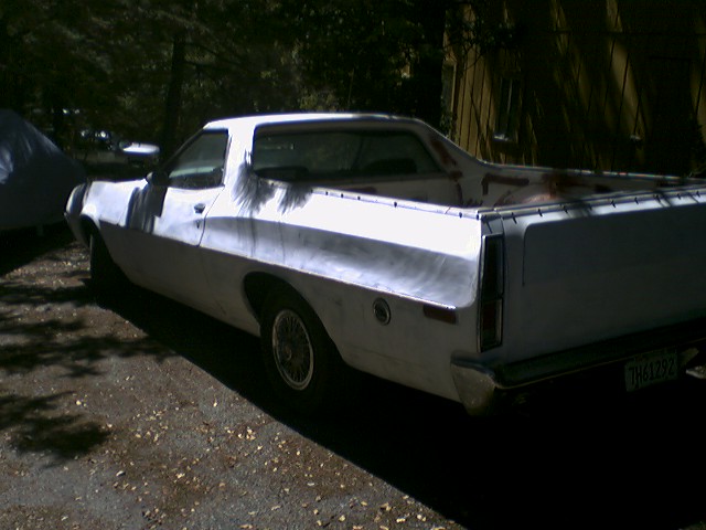 White 1972 Ford Ranchero from rear three-quarter angle in a shaded gravel driveway