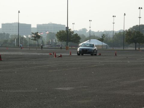 2001 Mercury Grand Marquis - An Audi A4 navigates a cone course in an open lot with buildings in the background.
