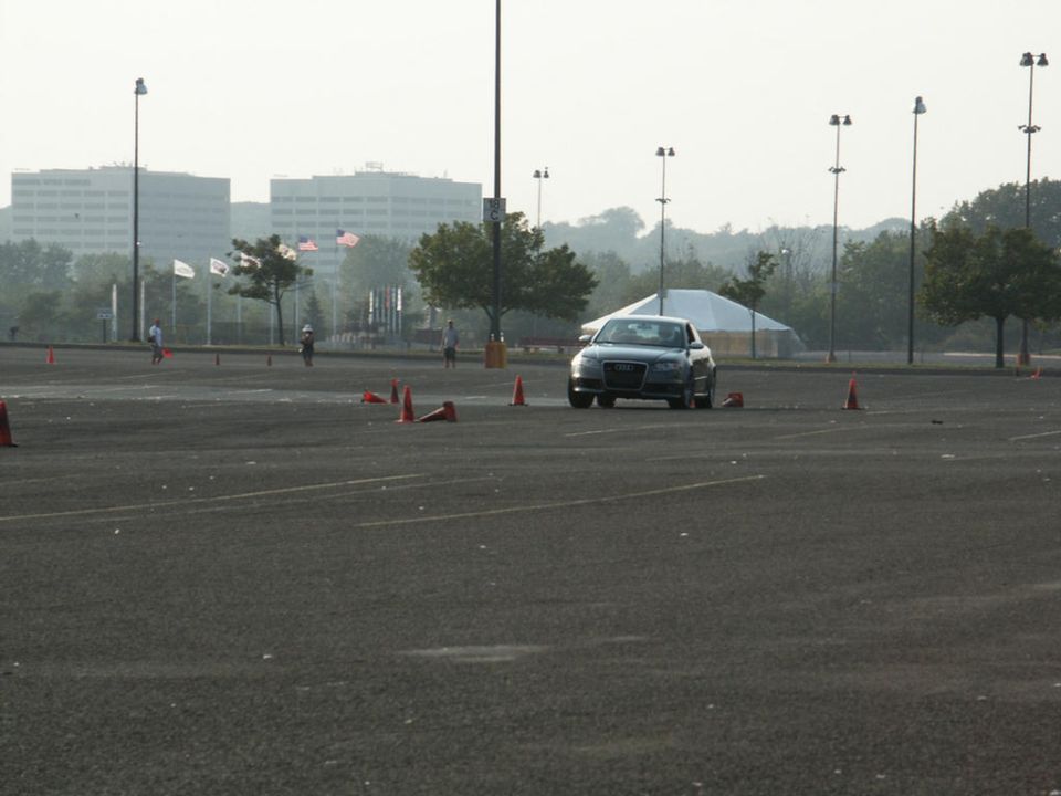 Gray Audi A4 on a cone course