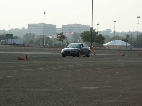 2001 Mercury Grand Marquis - Audi A4 sedan driving through a parking lot course with cones and buildings in the background.