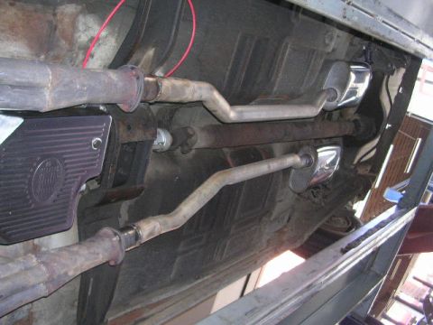 1975 Ford Ranchero - The underside of a 1975 Ford Ranchero reveals its dual exhaust system with polished mufflers.