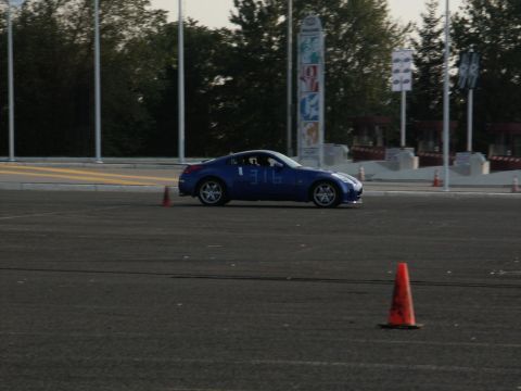 2001 Mercury Grand Marquis - Blue sports car with number 316 on door navigates an asphalt course with orange cones.