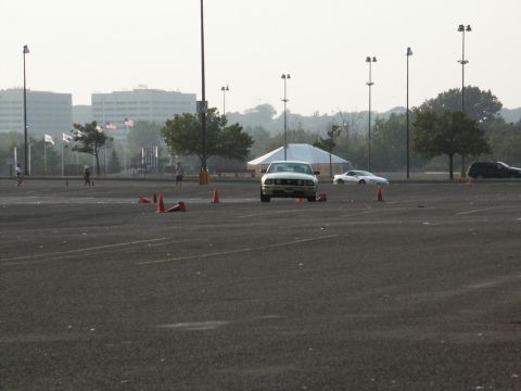 2001 Mercury Grand Marquis - A white sedan navigates a course marked by traffic cones in an open lot.