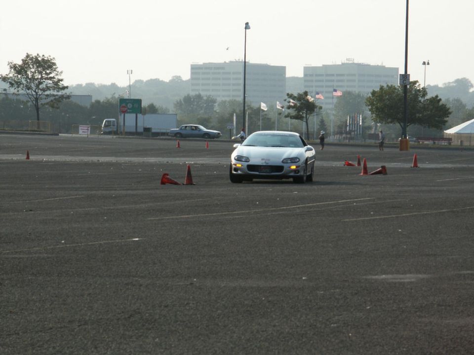 Silver sports car on a track with cones