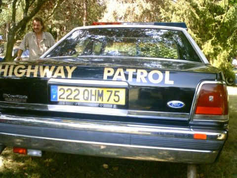 1991 Ford Crown Victoria - Rear view of a 1991 Ford Crown Victoria police car, marked 'HIGHWAY PATROL', with a license plate '222 QHM 75'.