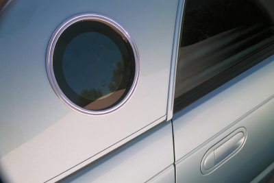 2002 Ford Thunderbird - Side profile of a 2002 Ford Thunderbird, highlighting its distinctive porthole window and chrome accents.