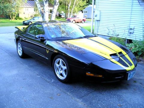 1994 Pontiac Trans Am - This black 1997 Pontiac Trans Am features yellow racing stripes and a rear spoiler.