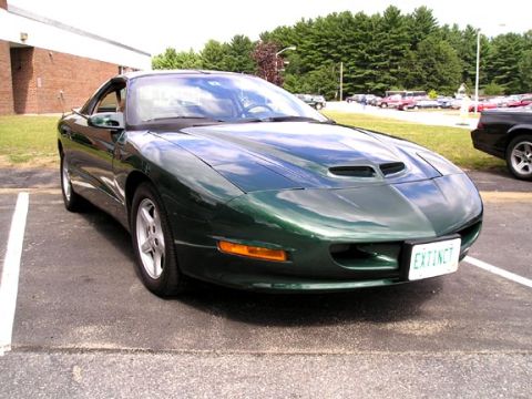 1994 Pontiac Trans Am - 1994 Pontiac Trans Am in a parking lot with other vehicles present.