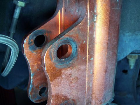 1995 Ford Probe - Close-up view of corroded metal parts, likely from a vehicle's suspension system.