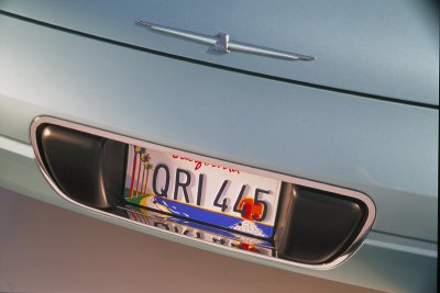 2002 Ford Thunderbird - The rear of a light blue 2002 Ford Thunderbird is visible, displaying a California license plate.