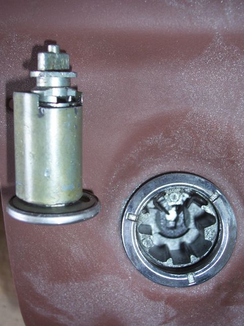 1978 Ford Bronco - Extreme close-up of two starter solenoid terminal studs mounted on a red-oxide primed panel: the left one is a tall cylindrical zinc-plated…