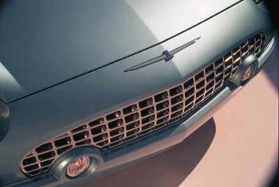 2002 Ford Thunderbird - Close-up of the distinctive grille and hood ornament on a light blue 2002 Ford Thunderbird.