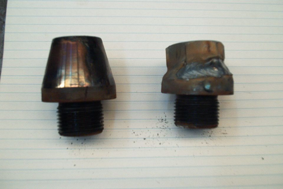 Two threaded metal parts, one conical and one hexagonal with welds