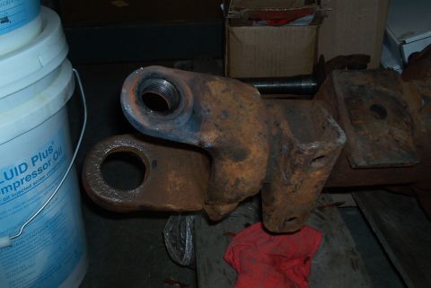 1983 Ford Bronco - Close-up of a heavily rusted metal component, possibly a bracket or linkage, with visible threading.