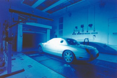 2002 Ford Thunderbird - A bank of blue lights illuminate a 2002 Ford Thunderbird that has pressure-sensitive paint applied on the driver's side window. The car and…