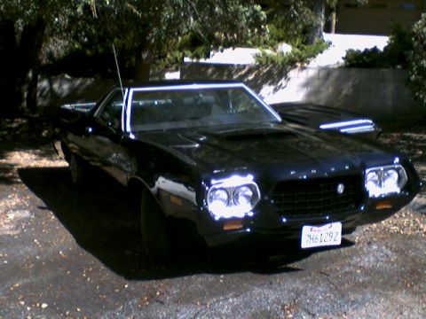 1972 Ford Ranchero - This black 1972 Ford Ranchero features a distinctive front end with quad headlights and a grille that matches its era.