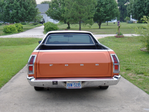 1979 Ford Ranchero - Orange 1979 Ford Ranchero pickup truck seen from the rear on a paved driveway.