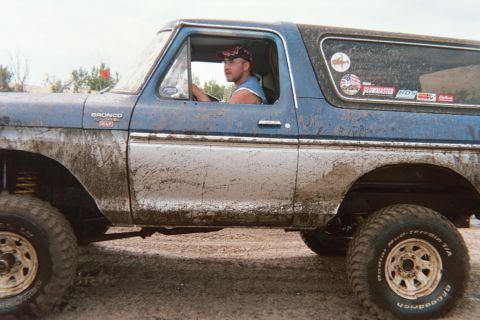 1979 Ford Bronco - Muddy 1979 Ford Bronco seen off-road with driver behind the wheel.