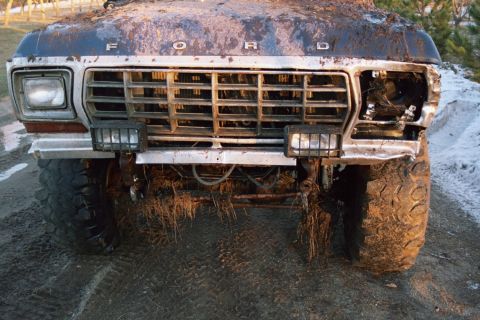 1979 Ford Bronco - This 1979 Ford Bronco is covered in mud, with one headlight missing and the grille showing.