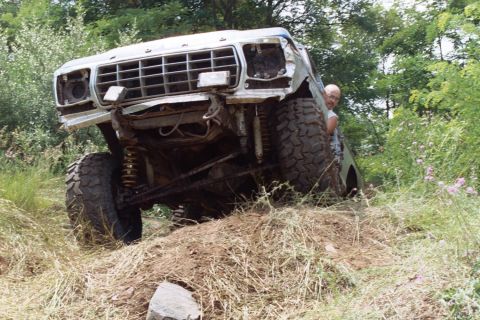 1979 Ford Bronco - This 1979 Ford Bronco is shown off-road with significant front-end damage.