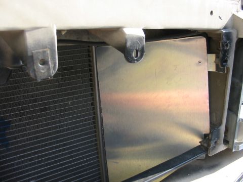 1985 Ford LTD Crown Victoria - Close-up view of a vehicle's radiator and a protective metal shield.