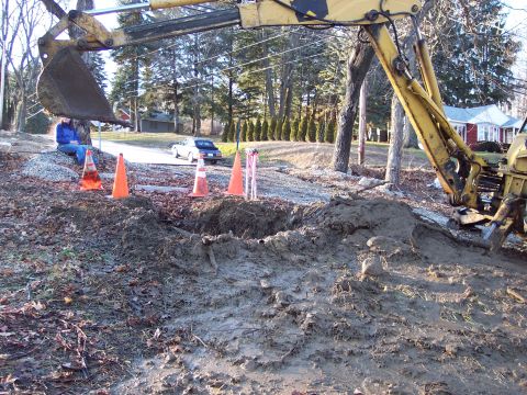 2001 Ford Crown Victoria - Construction site with an excavator and a parked car visible in the background.