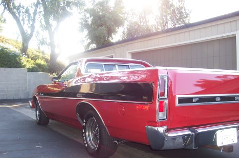 1973 Ford Ranchero - This 1973 Ford Ranchero features a distinctive black stripe along its side and a bright red finish.