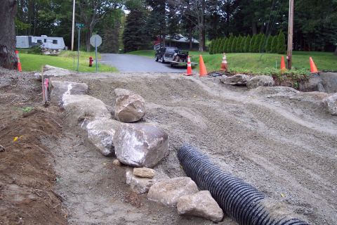 2001 Ford Crown Victoria - A construction scene shows rocks, dirt, and a large drainage pipe.