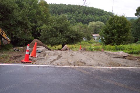 2001 Ford Crown Victoria - A construction scene is depicted with traffic cones and piles of dirt, indicating ongoing road work.