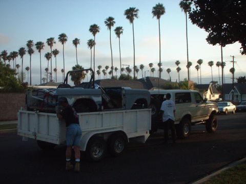 1966 Ford Bronco - A 1966 Ford Bronco body is loaded onto a trailer, with a second Ford Bronco nearby.