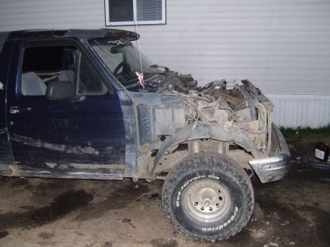 1989 Ford Bronco - This vehicle has significant damage to its front end, with the engine and surrounding components exposed.