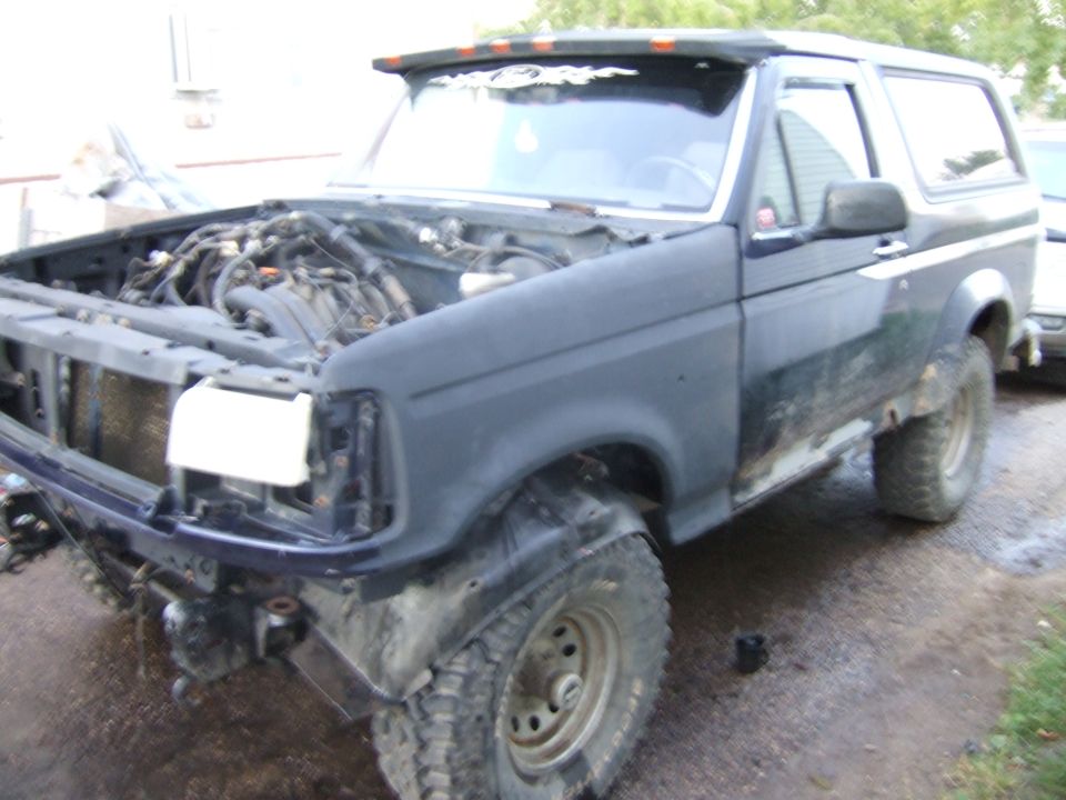1989 Ford Bronco, hood open, engine exposed, front end partially disassembled
